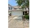 Tan two-story townhome with an attached two-car garage and a concrete driveway at 1048 Fairway Ln. # 1048, Conway, SC 29526