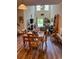 Open-concept living and dining area with high ceilings, wood floors, and large windows at 1048 Fairway Ln. # 1048, Conway, SC 29526