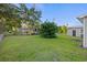 Spacious backyard with green grass, lush trees, and various structures, offering a serene outdoor setting at 109 Plum Ln., Andrews, SC 29510