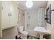 Cozy bathroom featuring vanity sink, tub with shower, toilet, botanical-themed curtain and decor, plus wall cabinet at 109 Plum Ln., Andrews, SC 29510