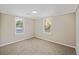 Bright bedroom with neutral walls, carpet, and two windows for natural light, offering a serene space at 109 Plum Ln., Andrews, SC 29510