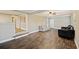 Bright living room showcasing hardwood floors, a ceiling fan, and open access to other rooms at 109 Plum Ln., Andrews, SC 29510