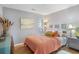 Bedroom featuring hardwood floors, modern art, and ample natural light streaming through the window at 1101 Possum Trot Rd. # D201, North Myrtle Beach, SC 29582