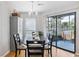 Bright dining room with hardwood floors, stylish chandelier, and sliding glass doors to outdoor patio at 1101 Possum Trot Rd. # D201, North Myrtle Beach, SC 29582
