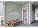 Welcoming condo entryway with a bench, cute wall decor and a cozy covered outdoor space at 1101 Possum Trot Rd. # D201, North Myrtle Beach, SC 29582