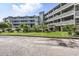 This building has multi-level balconies, a grassy area with shrubs, and plenty of parking for all its tenants at 1101 Possum Trot Rd. # D201, North Myrtle Beach, SC 29582