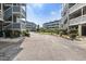 View of the community, with its multiple buildings surrounded by lush greenery, under a clear, sunny sky at 1101 Possum Trot Rd. # D201, North Myrtle Beach, SC 29582