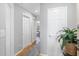 Bright hallway with updated flooring, crisp white doors, and a glimpse of the living space beyond at 1101 Possum Trot Rd. # D201, North Myrtle Beach, SC 29582