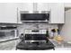 Well-equipped kitchen featuring stainless steel appliances, granite countertops and stylish subway tile backsplash at 1101 Possum Trot Rd. # D201, North Myrtle Beach, SC 29582