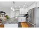 Renovated kitchen with stainless appliances, white cabinetry, and granite countertop space at 1101 Possum Trot Rd. # D201, North Myrtle Beach, SC 29582