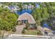 Panoramic aerial view of a charming brick home near a lake, embraced by lush greenery in a serene neighborhood at 1108 Surf Pointe Dr., North Myrtle Beach, SC 29582