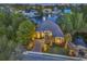 Stunning aerial view of brick home on a pond, showcasing mature landscaping, a driveway, and the property's location at 1108 Surf Pointe Dr., North Myrtle Beach, SC 29582