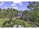 Lush backyard scene overlooking a lake, with palm trees and staircase leading to a patio at 1108 Surf Pointe Dr., North Myrtle Beach, SC 29582