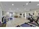 A finished basement area showcasing a home gym, lounge space, and access to the outdoors at 1108 Surf Pointe Dr., North Myrtle Beach, SC 29582