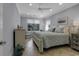 A serene bedroom with a plush bed, neutral tones, and natural light filtering through the windows at 1108 Surf Pointe Dr., North Myrtle Beach, SC 29582