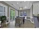 This dining room has wood-look floors, a modern light fixture, and sliding glass doors to the balcony at 1108 Surf Pointe Dr., North Myrtle Beach, SC 29582