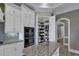 This open kitchen features a pantry, white cabinets, granite countertops, stainless steel appliances, and recessed lighting at 1108 Surf Pointe Dr., North Myrtle Beach, SC 29582