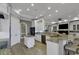 Open kitchen with island, white cabinets, stainless appliances, granite countertops, recessed lighting, and wood-look floors at 1108 Surf Pointe Dr., North Myrtle Beach, SC 29582