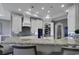 This open kitchen features a pantry, white cabinets, granite countertops, stainless steel appliances, and recessed lighting at 1108 Surf Pointe Dr., North Myrtle Beach, SC 29582