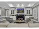 Cozy living room featuring a fireplace with tv overhead, white built-in cabinets, and comfortable seating at 1108 Surf Pointe Dr., North Myrtle Beach, SC 29582