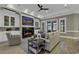 Spacious living room with fireplace and TV, hardwood floors, comfortable seating, and access to outdoor living space at 1108 Surf Pointe Dr., North Myrtle Beach, SC 29582