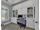 This office features built-in cabinets and shelving, wood-look floors, and a window with shutters at 1108 Surf Pointe Dr., North Myrtle Beach, SC 29582