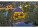 This home's backyard boasts many windows and a sprawling lawn that lead to a waterfront with a retaining wall at 1108 Surf Pointe Dr., North Myrtle Beach, SC 29582