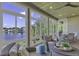 Inviting sunroom featuring large windows with waterfront views, comfortable wicker seating and ceiling fan at 1108 Surf Pointe Dr., North Myrtle Beach, SC 29582
