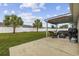Relax on the covered back patio with an outdoor seating area overlooking the landscaped yard and palm trees at 1205 Cymmer Ct., Conway, SC 29527