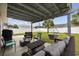 A covered patio area features an outdoor seating area, a grill, and a fenced-in backyard at 1205 Cymmer Ct., Conway, SC 29527