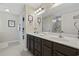 This bathroom features a double sink vanity with a large mirror and updated fixtures at 1205 Cymmer Ct., Conway, SC 29527