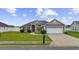 Charming single-story home with well-manicured lawn, red door, and two-car garage at 1205 Cymmer Ct., Conway, SC 29527