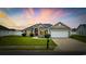 Charming single-story home with well-manicured lawn, red door, and two-car garage at 1205 Cymmer Ct., Conway, SC 29527