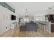 Open-concept living room with hardwood floors flowing into the kitchen and dining area at 1205 Cymmer Ct., Conway, SC 29527
