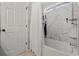 A stylish shower features updated fixtures, a white marble surround, and a built-in shelf at 1205 Cymmer Ct., Conway, SC 29527
