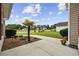Concrete walkway with palm tree and landscaping in front of house at 1205 Cymmer Ct., Conway, SC 29527