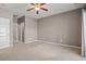 Bedroom featuring a ceiling fan, en-suite bathroom, and neutral tones at 121 Parmelee Dr. # D, Murrells Inlet, SC 29576