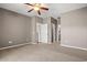 Bedroom with neutral tones, a ceiling fan, and doorways leading to en-suite bathroom at 121 Parmelee Dr. # D, Murrells Inlet, SC 29576