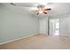 Spacious bedroom features neutral walls, carpet, and a ceiling fan with natural light at 121 Parmelee Dr. # D, Murrells Inlet, SC 29576