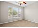Neutral bedroom features a large window for natural light and neutral carpet flooring creating a cozy atmosphere at 121 Parmelee Dr. # D, Murrells Inlet, SC 29576