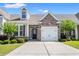 Charming home featuring a stone-accented facade, attached garage, and well-maintained landscaping with green lawn at 121 Parmelee Dr. # D, Murrells Inlet, SC 29576