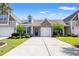Attractive home showing the well-manicured front lawn, attached garage, and inviting stone detail around the entrance at 121 Parmelee Dr. # D, Murrells Inlet, SC 29576