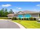 Exterior of community center building with blue doors, nice landscaping, and a paved road at 121 Parmelee Dr. # D, Murrells Inlet, SC 29576