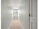 Hallway featuring a window at the end of the hall, carpet, and fresh paint at 121 Parmelee Dr. # D, Murrells Inlet, SC 29576