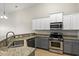 Bright kitchen showcasing granite counters, stainless appliances, modern two-tone cabinetry, and open layout at 121 Parmelee Dr. # D, Murrells Inlet, SC 29576