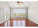 Sun-filled sunroom featuring hardwood floors, large windows overlooking a serene water view, and access to the outdoors at 121 Parmelee Dr. # D, Murrells Inlet, SC 29576