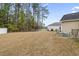 Expansive backyard with mature trees, a white fence, and a patio with outdoor seating at 1222 Midtown Village Dr., Conway, SC 29526