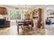 Dining area with wood table and chairs next to sliding glass door and view of vintage furnishings at 1222 Midtown Village Dr., Conway, SC 29526