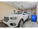 Spacious garage interior with a white SUV parked, storage and garage door at 1222 Midtown Village Dr., Conway, SC 29526