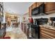 Kitchen with dark wood cabinets and countertops with view to a nearby dining room at 1222 Midtown Village Dr., Conway, SC 29526